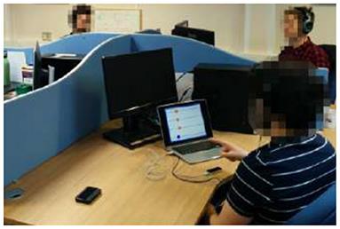 Modeling Frequency Reduction in Human Groups Performing a Joint Oscillatory Task